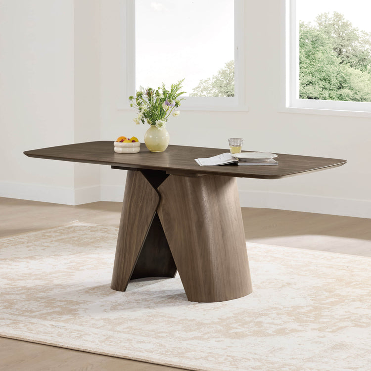 Elowen sculptural wood base dining table in walnut with angled legs