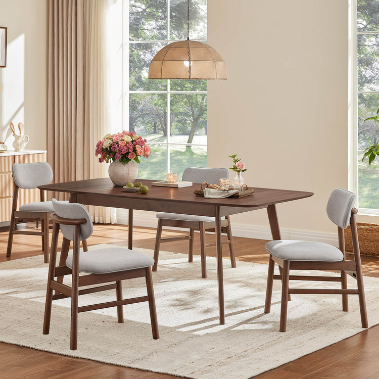 Hilda dark wood extendable dining table, tapered legs, rounded corners, 4 grey chairs in dining room.