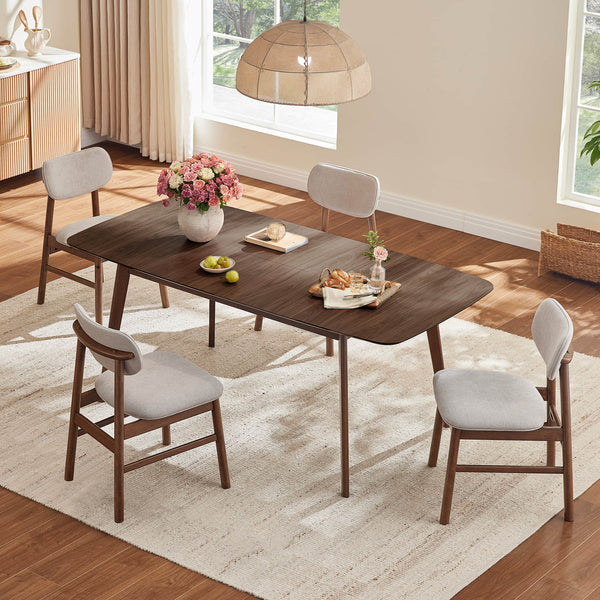 Hilda dark wood extendable dining table, tapered legs, rounded corners, light grey chairs, dining room scene.