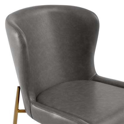 Close-up of Golda Dining Chair in grey faux leather with elegant brass legs - CHITA Living