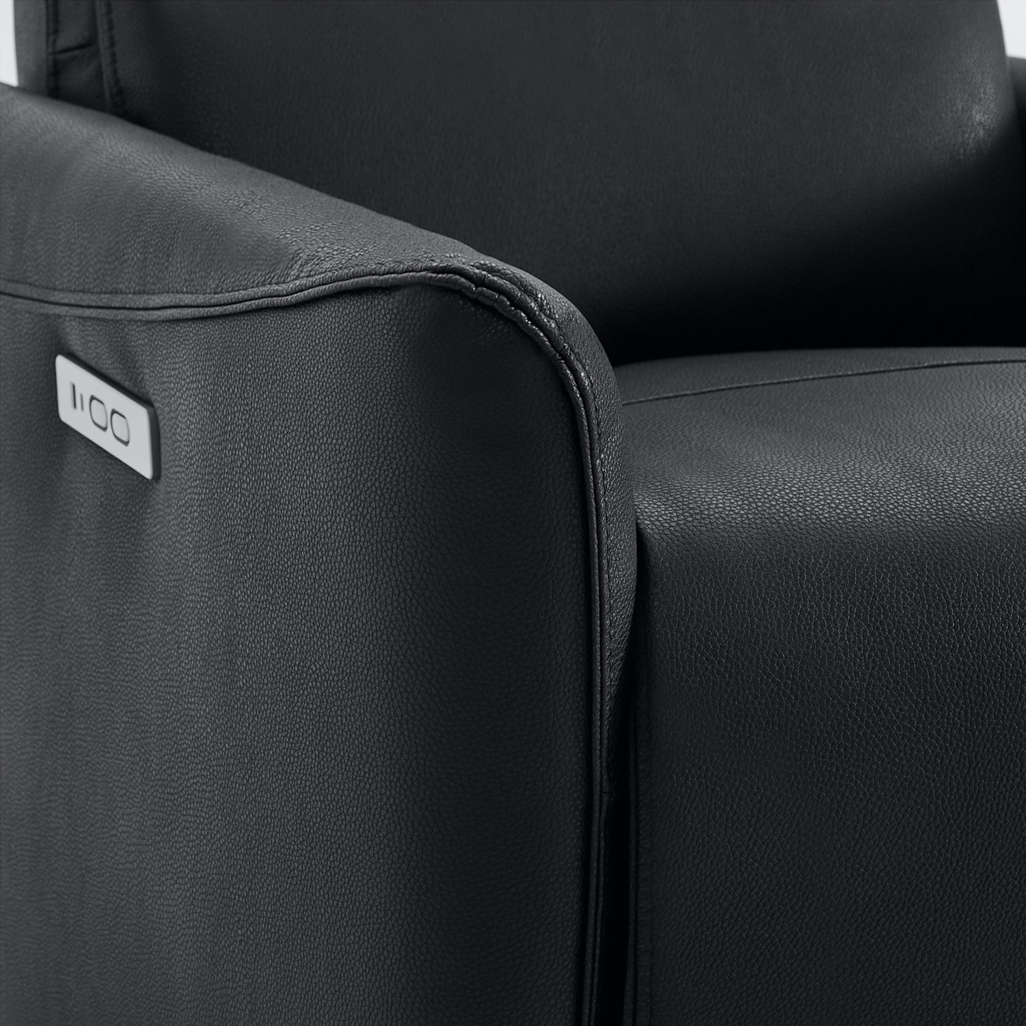 Close-up of black leather Tracee recliner with power button detail - CHITA Living