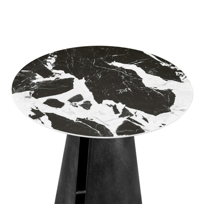 Black ceramic round side table with black tapered pedestal base, featuring unique white veining.