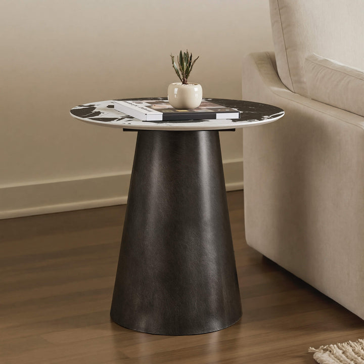 Natalie Black Sintered Stone Round Side Table styled beside a sofa