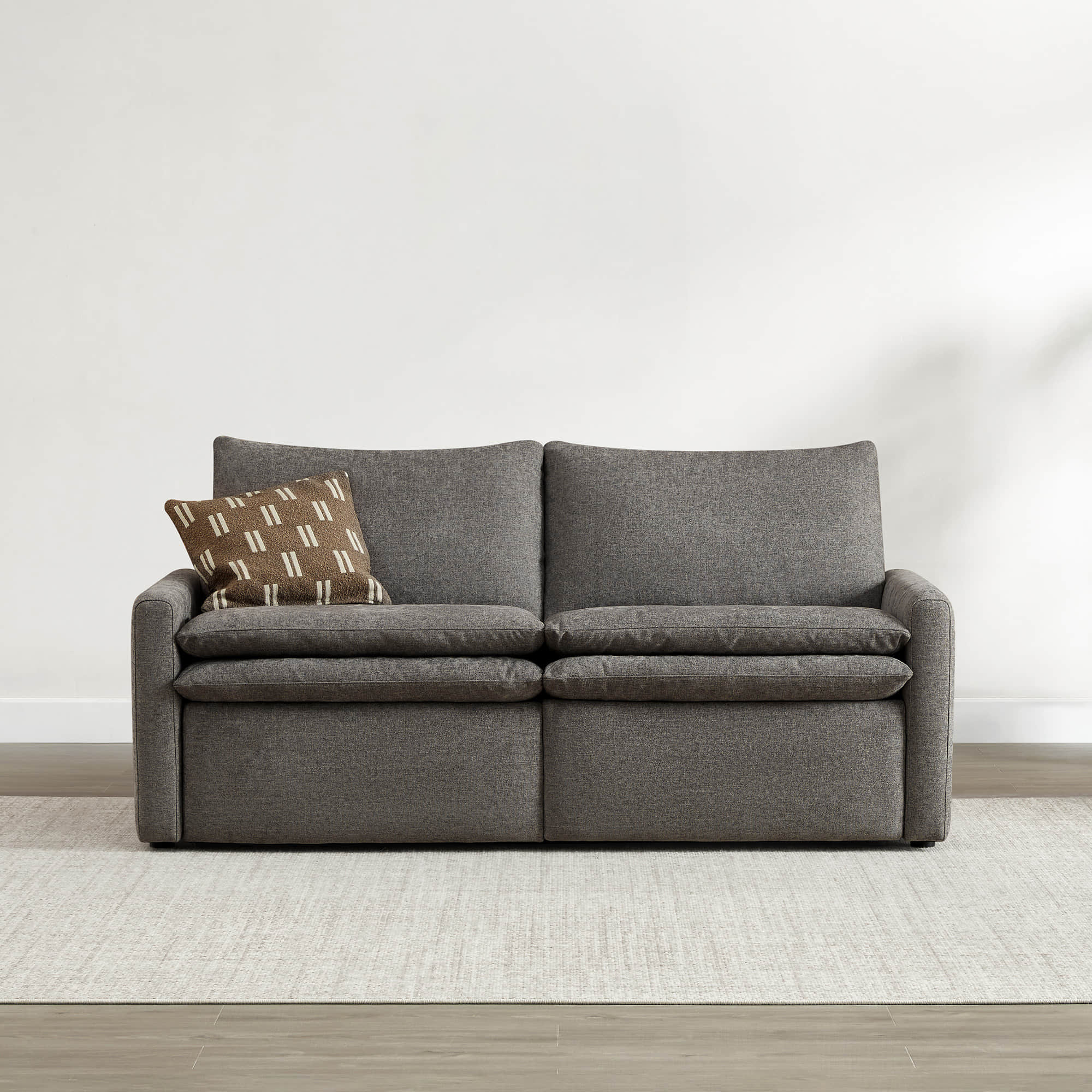 Front view of Ohana 2-Seat Motion Modular Sofa in soft gray fabric with decorative pillow - CHITA Living