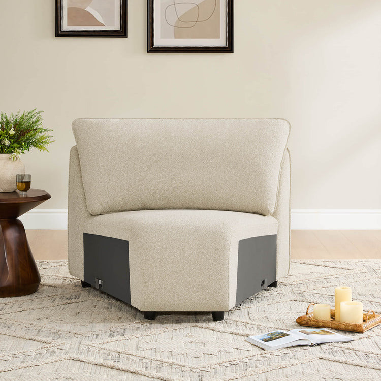 Teleri modular corner seat in sand color with dark gray accents and wooden legs, on a textured rug.