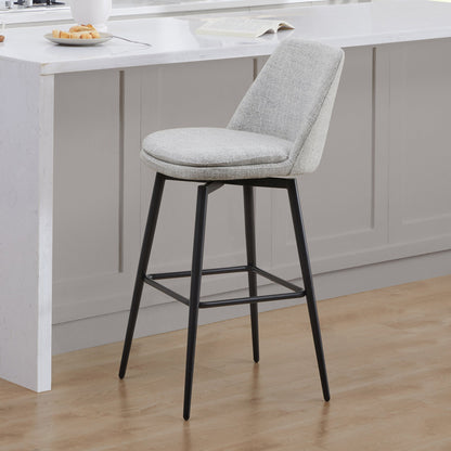 Eli swivel bar stool with light gray fabric seat and modern black metal frame in a kitchen - CHITA Living