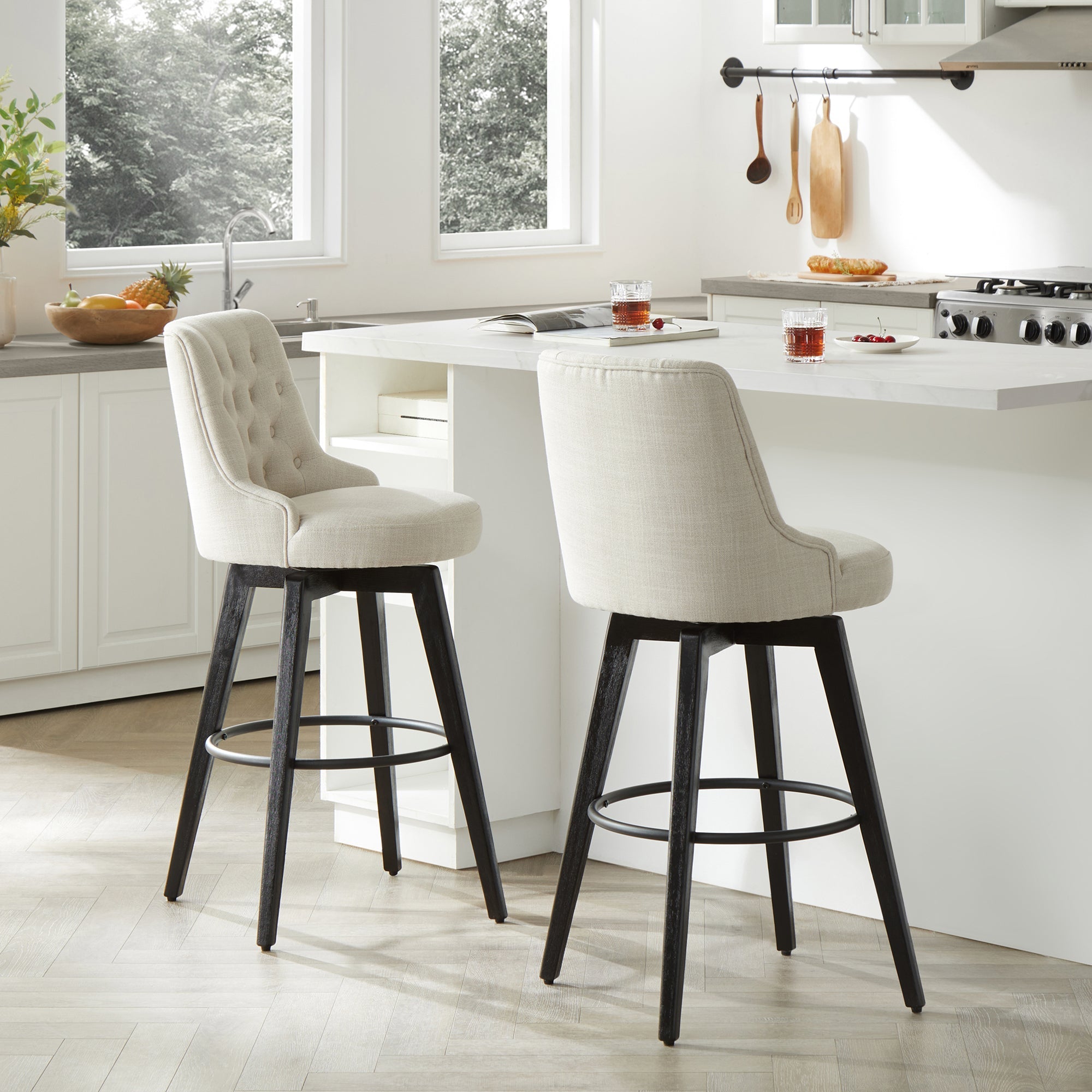 Elegant beige tufted swivel bar stools with dark wood legs in modern kitchen setting - CHITA Living