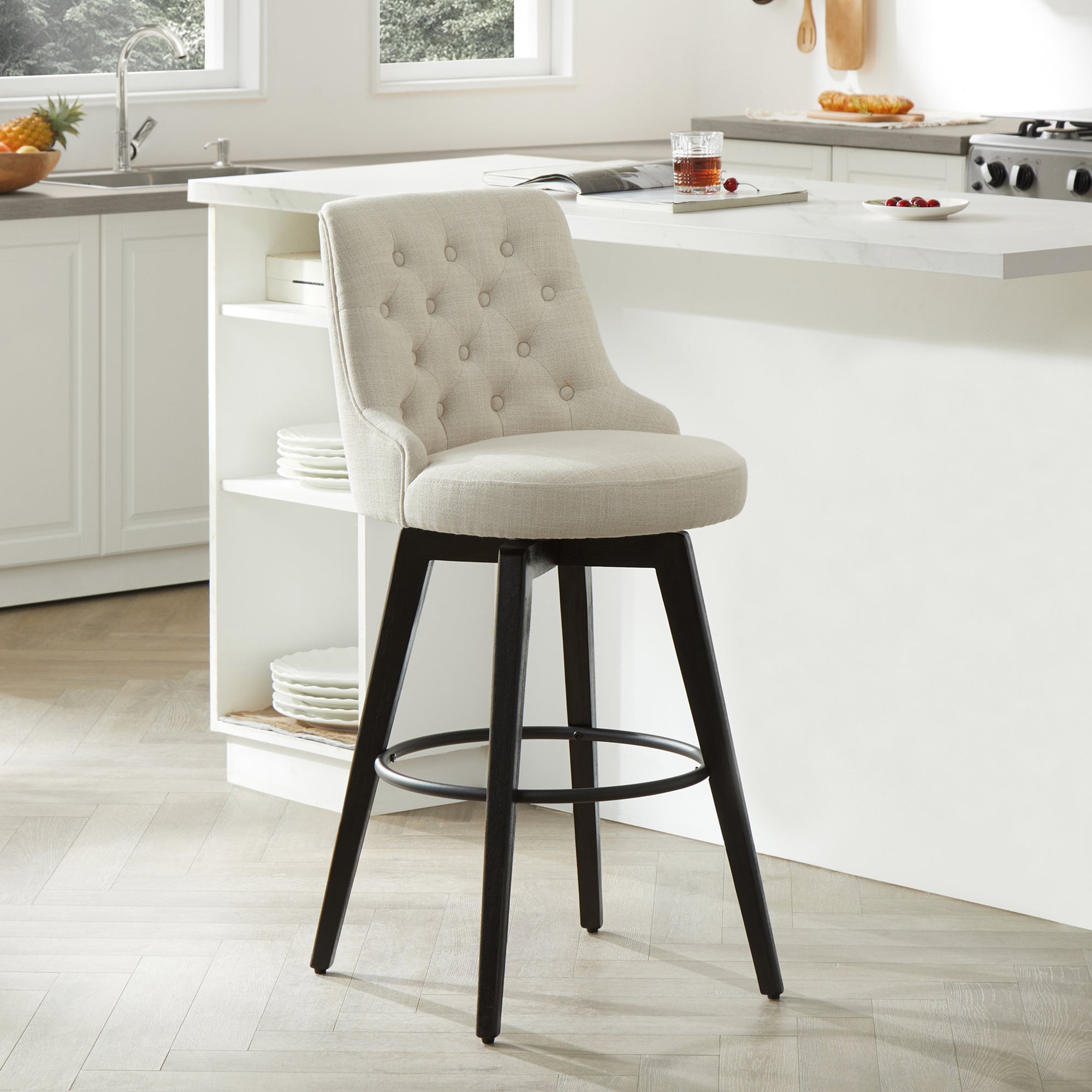 Beige tufted swivel bar stool with black legs in a modern kitchen - CHITA Living