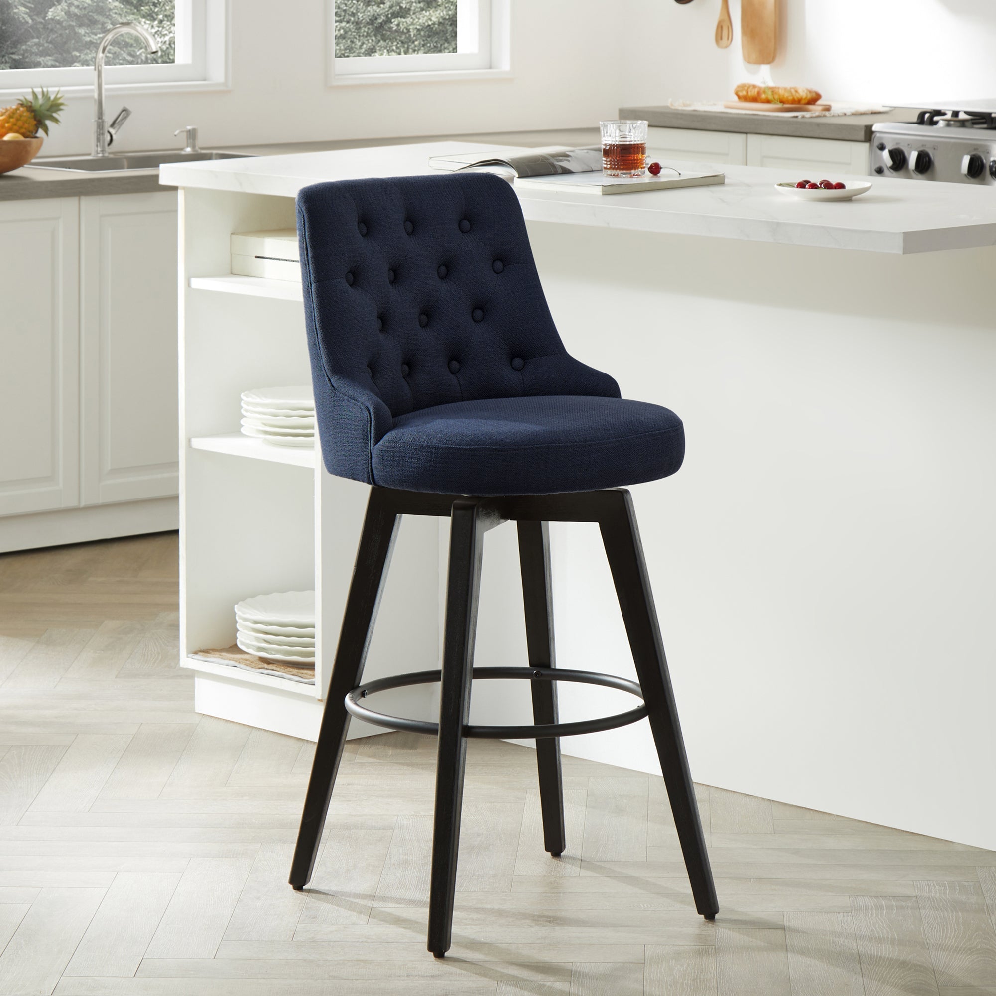 Navy blue tufted swivel bar stool with black legs in contemporary kitchen - CHITA Living