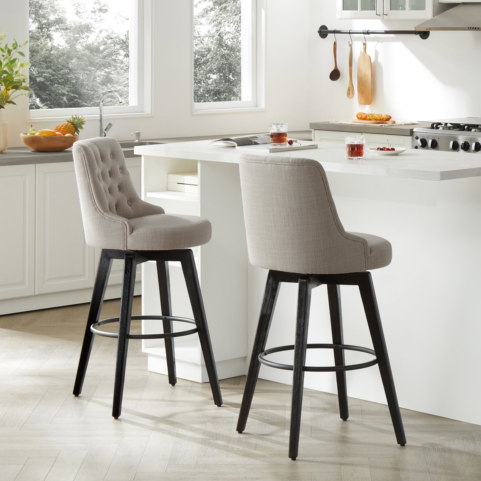 Beige tufted swivel bar stools with black legs in a modern kitchen setting - CHITA Living