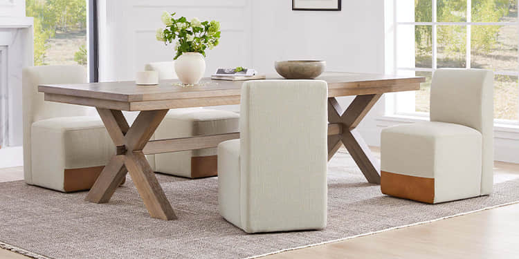 Dining room with wooden table and beige chairs in a bright room.