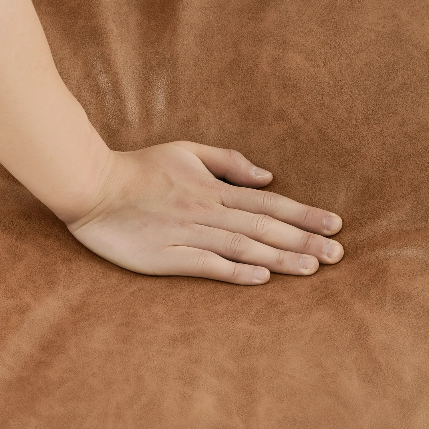 Hand placed on a brown leather surface
