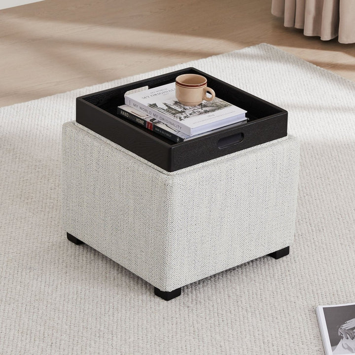 Stylish cube ottoman with tray, books, and mug on textured cream rug - CHITA Living