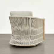 An outdoor bistro set chair with a woven back and cream cushion, showcasing its detailed design.