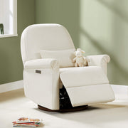 Aurora Power Swivel Nursery Glider Recliner, beige, in a nursery with a stuffed sheep and books on the floor.