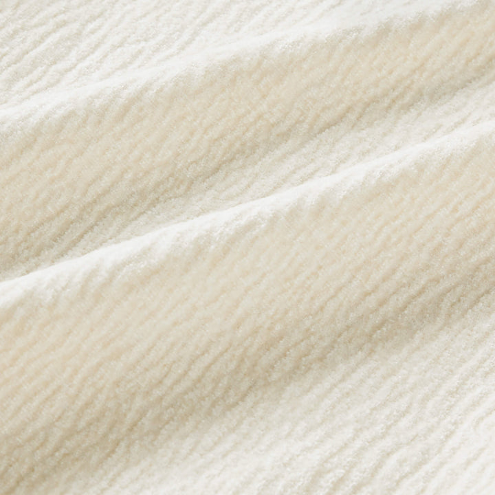 Aurora Power Swivel Nursery Glider Recliner, beige, close-up of soft, textured fabric.