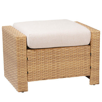 A wicker ottoman with a beige cushion on top