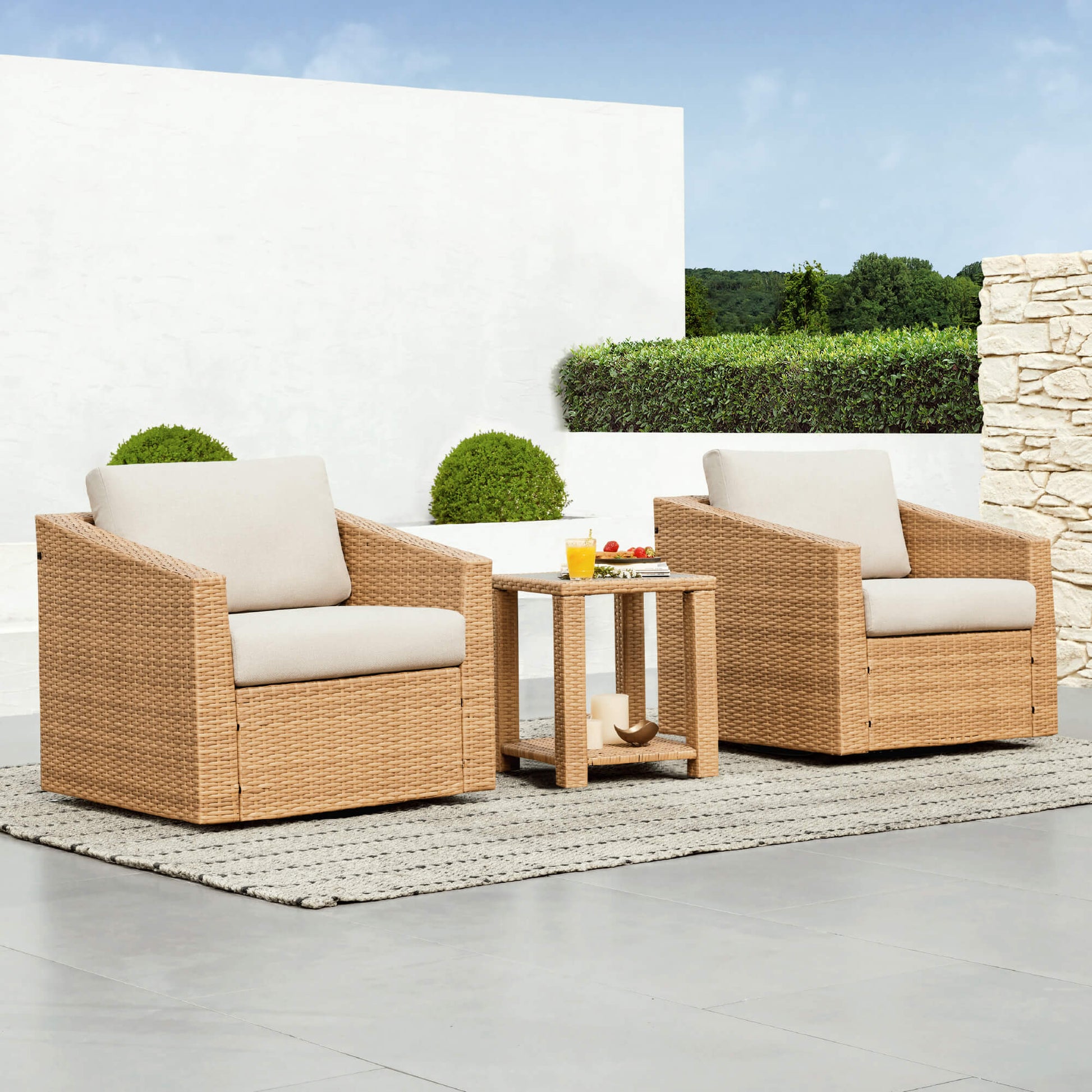 Calum Rattan Outdoor Bistro Set with beige cushions, ideal for modern patio spaces - CHITA Living