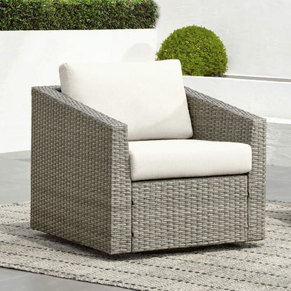 Calum Rattan outdoor chair with thick beige cushion, perfect for stylish patio relaxation - CHITA Living