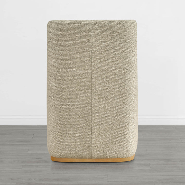 Beige textured wingback dining chair with a curved wooden base in minimalist decor - CHITA Living
