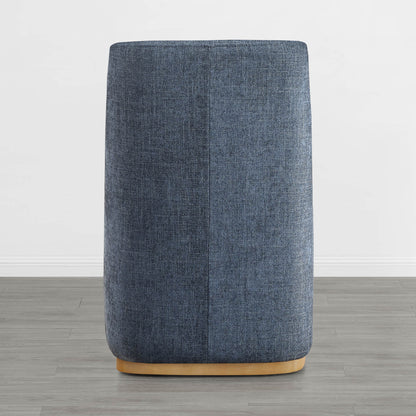 Back of blue wingback chair with curved wooden base in a minimalist room - CHITA Living