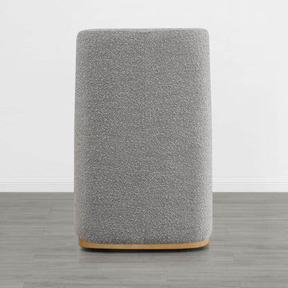 Back view of a gray upholstered dining chair with a wooden base in a minimalist interior - CHITA Living