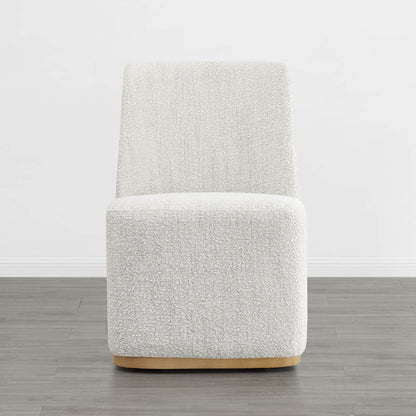 Textured cream wingback dining chair with a curved wooden base in a minimalist setting - CHITA Living