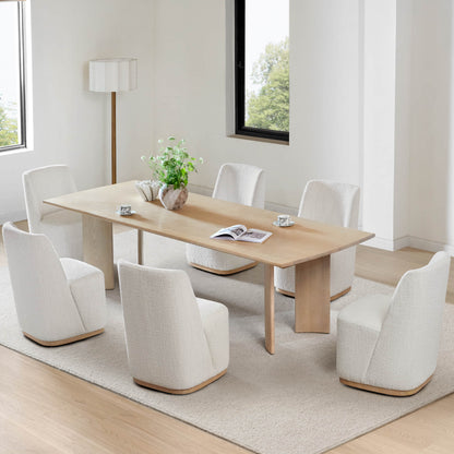 Bright dining room with cream wingback chairs around a light wooden dining table - CHITA Living