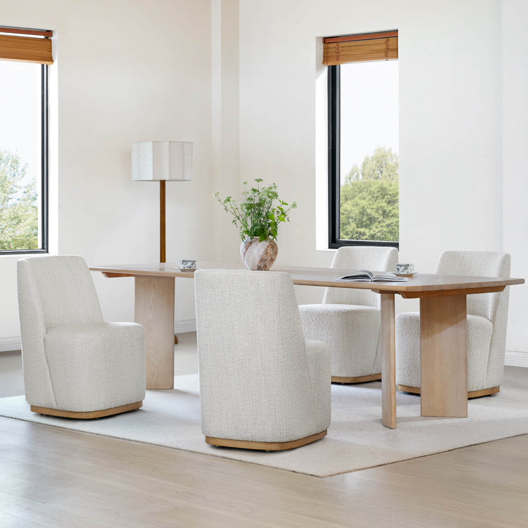 Bright dining room with cream textured wingback chairs surrounding a wooden dining table - CHITA Living