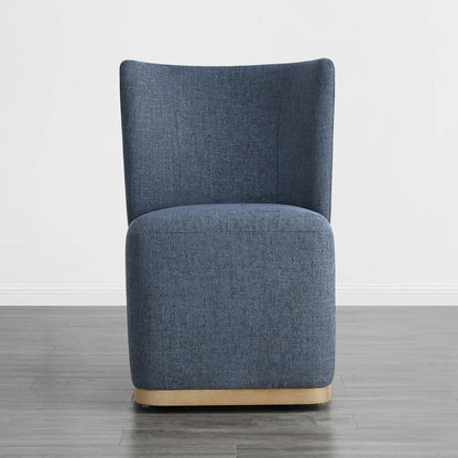 Blue wingback dining chair with curved wooden base in a modern minimalist room - CHITA Living
