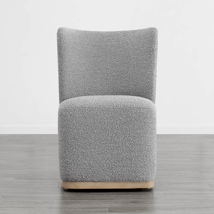 Gray boucle upholstered dining chair with a curved design in a modern setting - CHITA Living