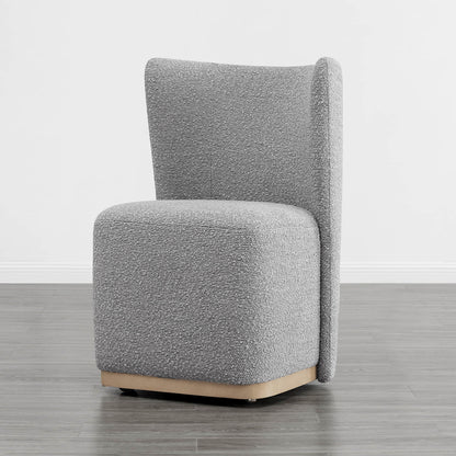Gray textured upholstered wingback chair with a curved base in a minimalist setting - CHITA Living