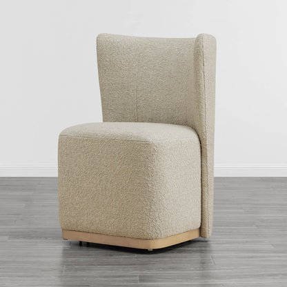 Curved cream wingback chair with textured fabric and wooden base in minimalist room - CHITA Living