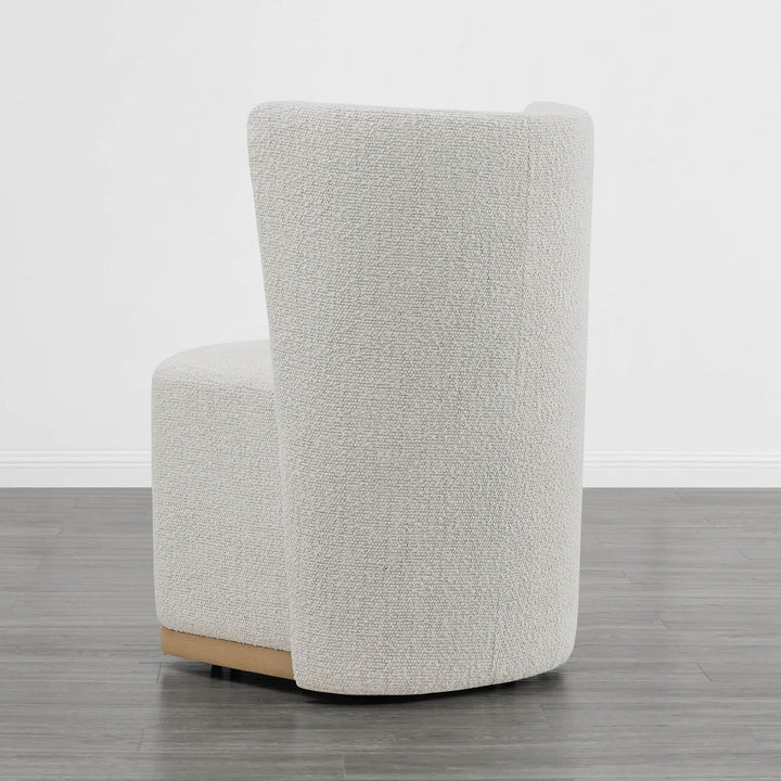 Back view of cream textured wingback chair with curved design in minimalist setting - CHITA Living