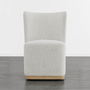 Cream textured wingback dining chair with curved base in modern minimalist room - CHITA Living