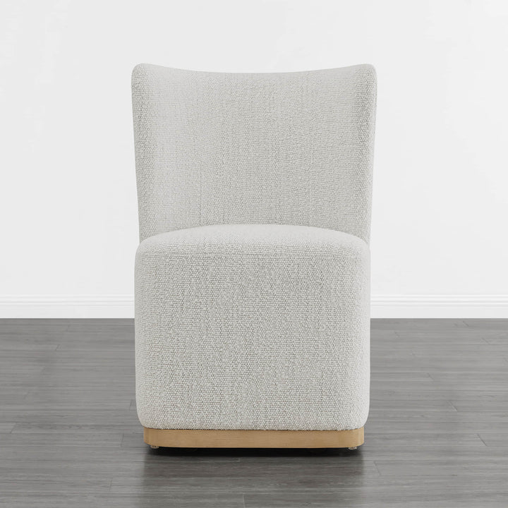 Cream textured wingback dining chair with curved base in modern minimalist room - CHITA Living