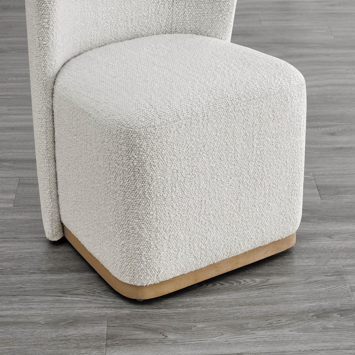 Close-up of textured cream dining chair base with curved wooden detail - CHITA Living