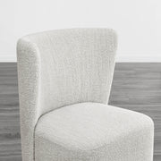 Textured cream wingback dining chair with a stylish curved design in modern interior - CHITA Living