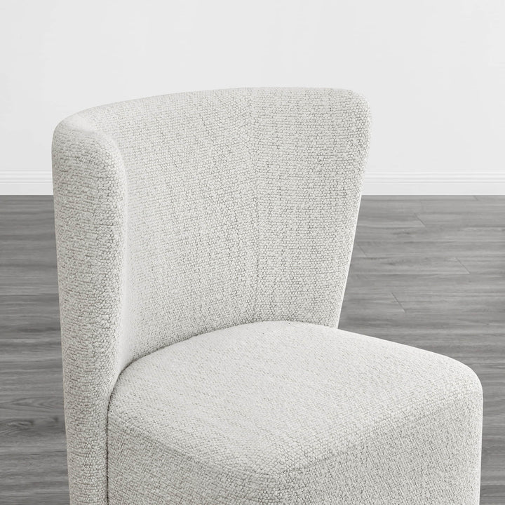 Textured cream wingback dining chair with a stylish curved design in modern interior - CHITA Living