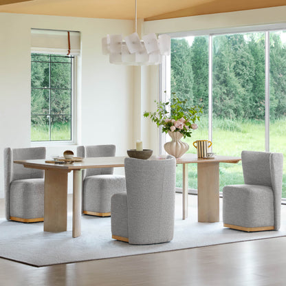 Stylish gray textured wingback chairs around a wooden dining table in a bright room - CHITA Living