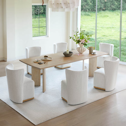 Elegant dining room with white textured wingback chairs around a wooden table - CHITA Living