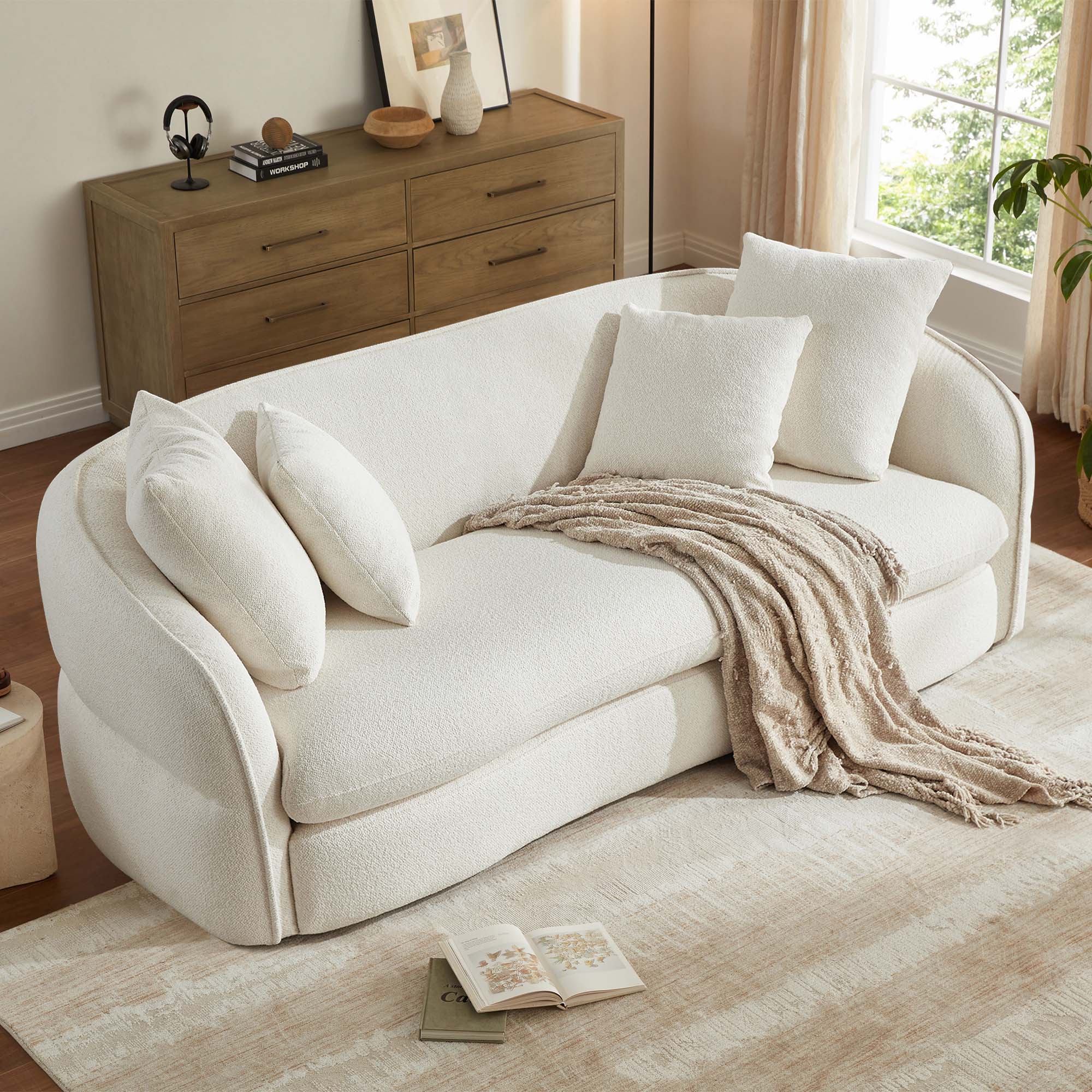 Close-up of a white 3-seater sofa with a cozy throw blanket.