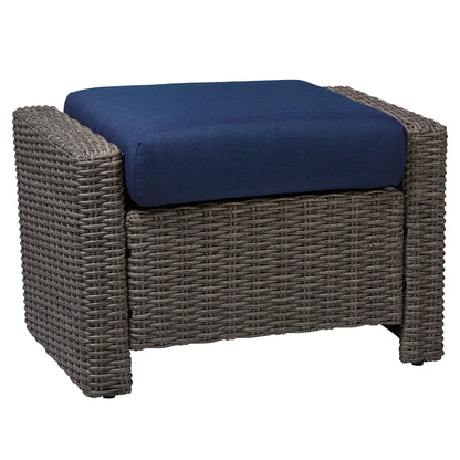 Elara rattan ottoman with navy cushion for outdoor seating and relaxation - CHITA Living
