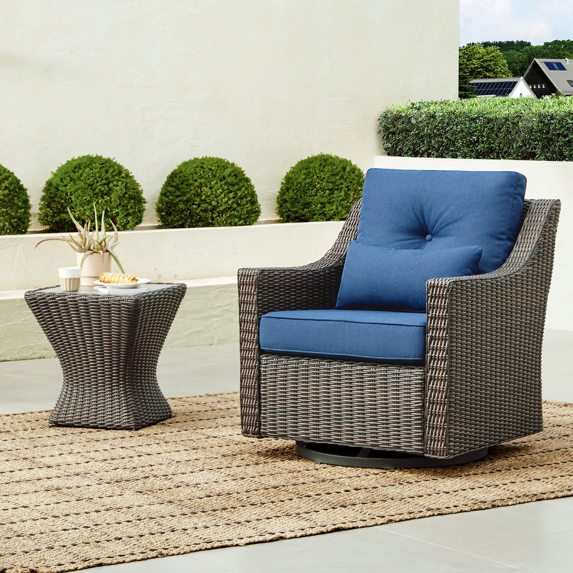 Stylish Elara Rattan Bistro Set with blue cushions and a round side table on patio - CHITA Living