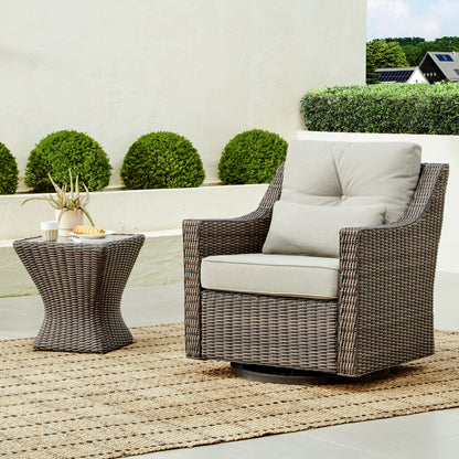 Elara Rattan Outdoor Chair with light gray cushion beside woven side table, perfect for patios - CHITA Living