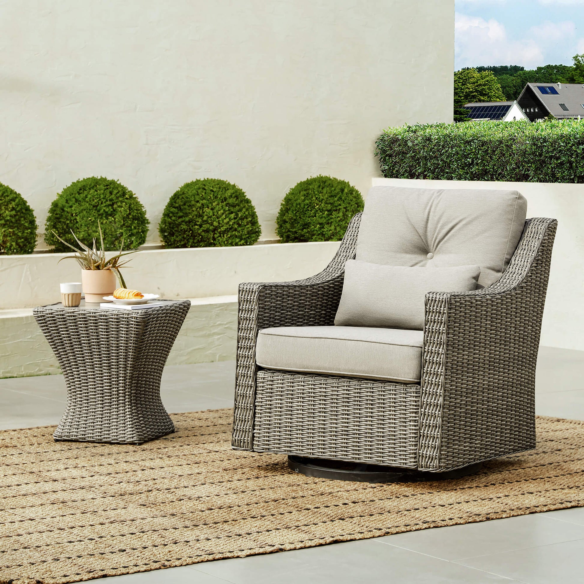 Elara Rattan Outdoor Chair with gray cushions and woven side table, perfect for patios - CHITA Living