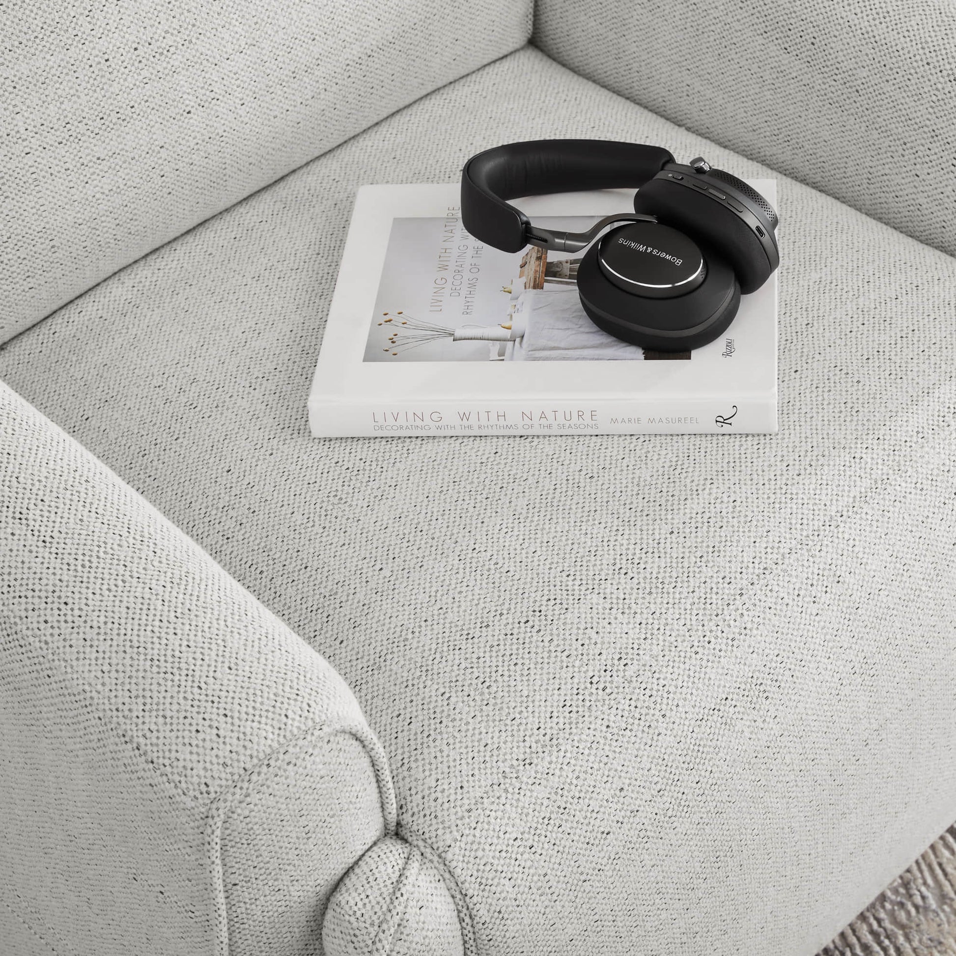 Elysian Power Swivel Glider Recliner with book and headphones on soft white upholstery - CHITA Living