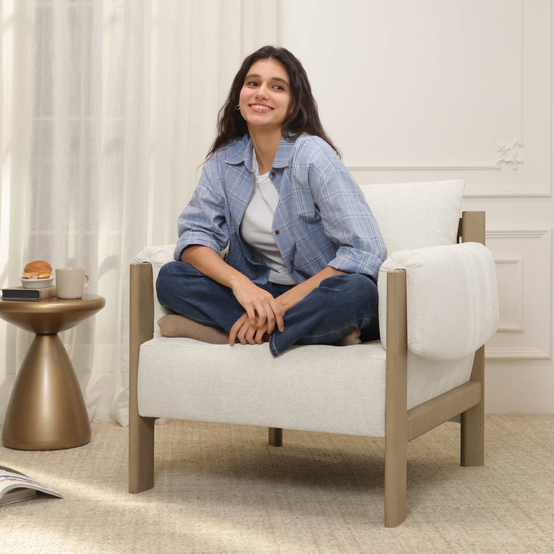 Harbor Accent Chair, a harmony of wood and soft upholstery, with a woman sitting in a cozy living room.