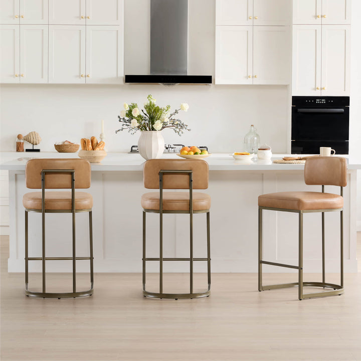 Three brown leather bar stools arranged at a bright kitchen counter.