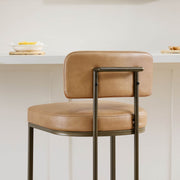 Detailed view of a premium leather bar stool with a sturdy metal frame, adding elegance to your kitchen.